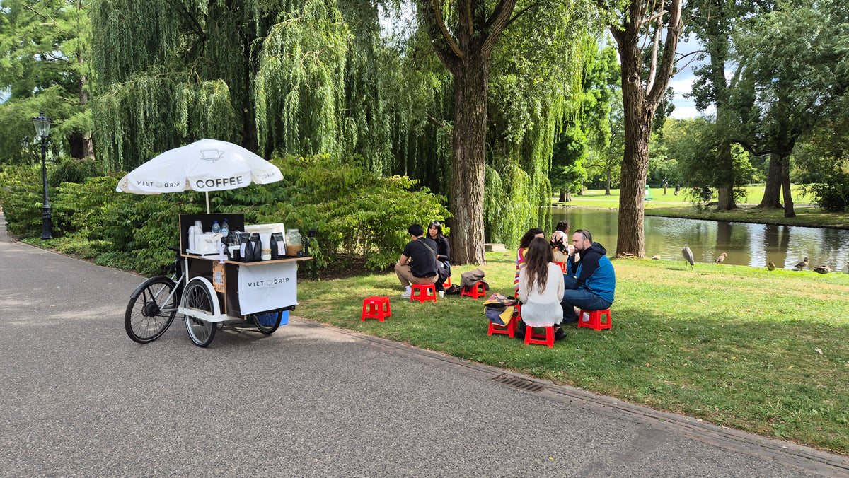 The Viet Drip coffee bike and little red stools in Amsterdam’s Oosterpark